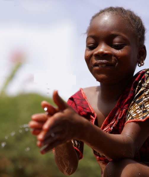 Cheerful Little African School Girl Drinks Safe Drinkable Fresh